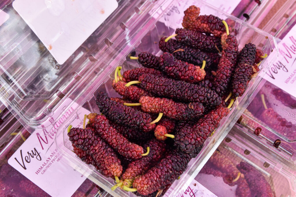 Mulberries in a berry container at the farmers market