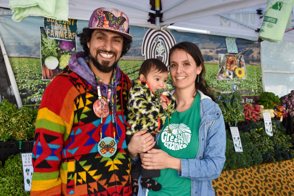 Rudy and Maria, holding baby Rodolfo, at Green Thumbs Farm's stand at Mission Community Market